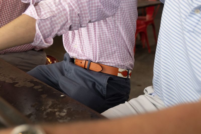 A beaded belt worn at a table